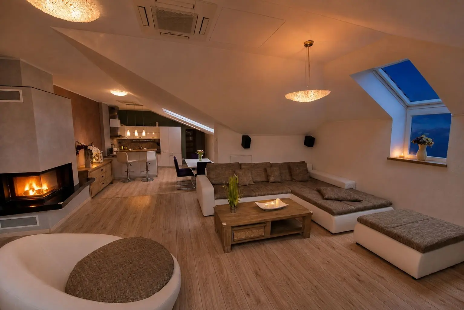 Living room with the fireplace lit in the evening